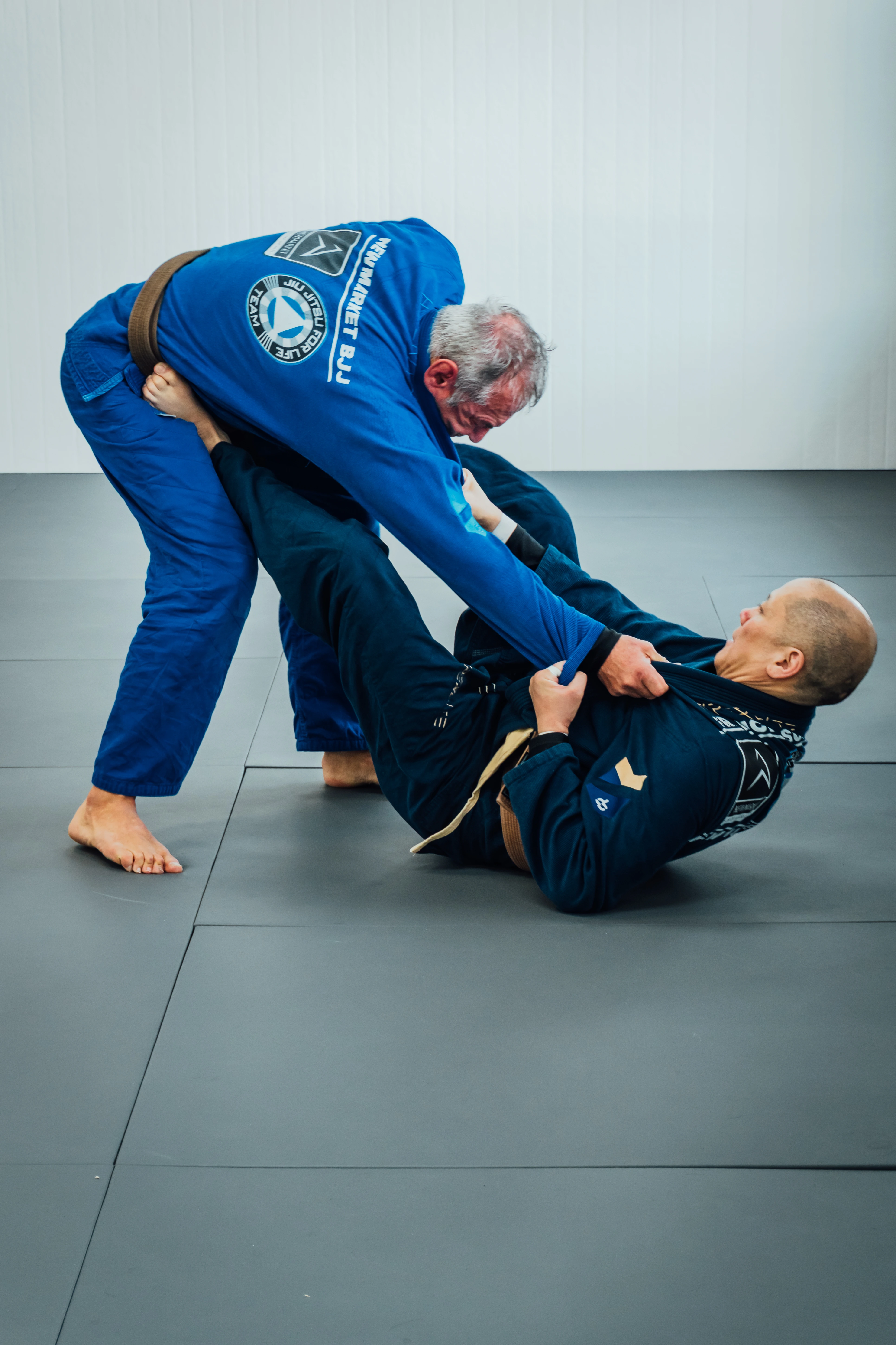 Students rolling live on the mat